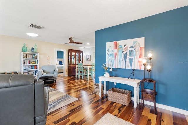 living room with ceiling fan and hardwood / wood-style flooring