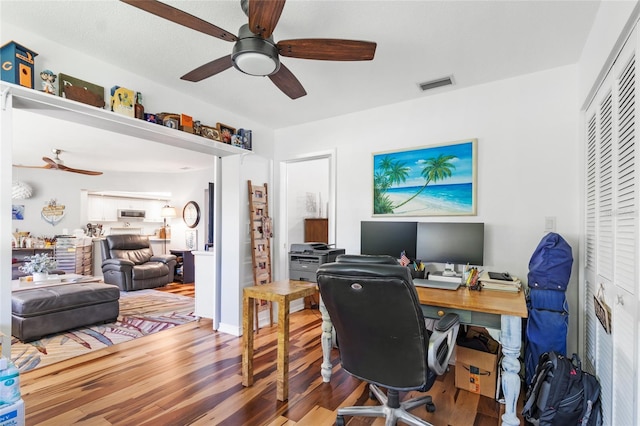 office space featuring hardwood / wood-style floors and ceiling fan