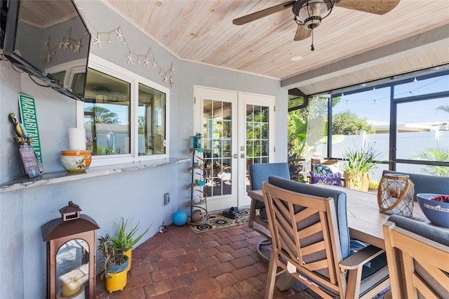 sunroom featuring french doors, ceiling fan, and wood ceiling