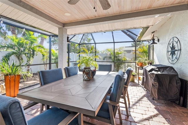 sunroom / solarium featuring ceiling fan and wooden ceiling