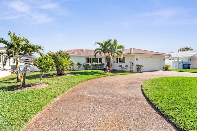 ranch-style home with stucco siding, curved driveway, an attached garage, and a front lawn
