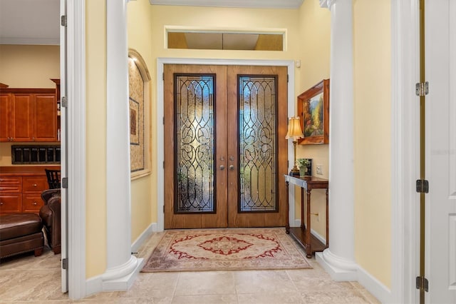 tiled foyer with french doors and ornamental molding