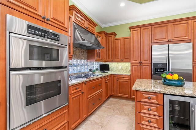 kitchen with ventilation hood, wine cooler, ornamental molding, appliances with stainless steel finishes, and tasteful backsplash