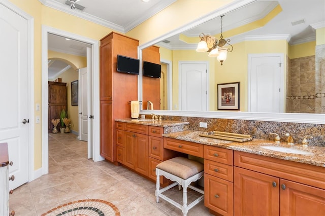 bathroom with a chandelier, vanity, crown molding, and tile patterned flooring