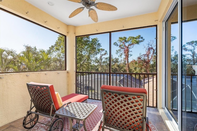 sunroom / solarium featuring ceiling fan and plenty of natural light