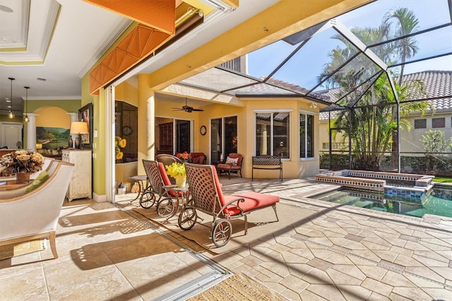 view of patio / terrace with a lanai, an in ground hot tub, and ceiling fan