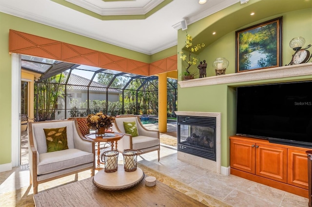 sunroom featuring a multi sided fireplace and a tray ceiling