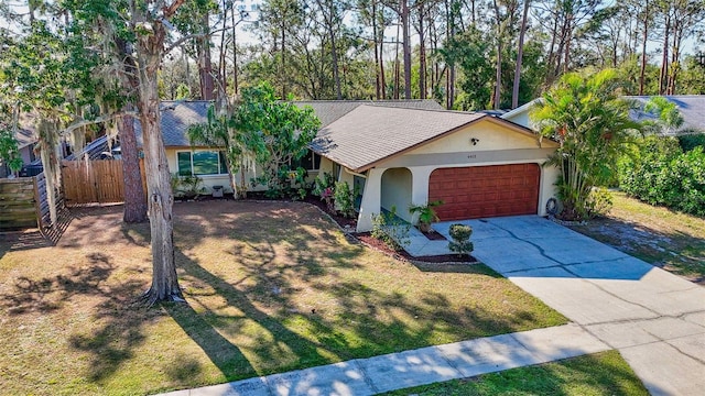 ranch-style home with a garage and a front lawn