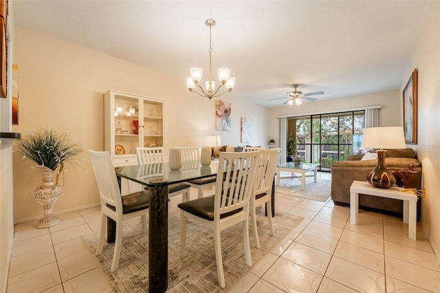 tiled dining area with ceiling fan with notable chandelier