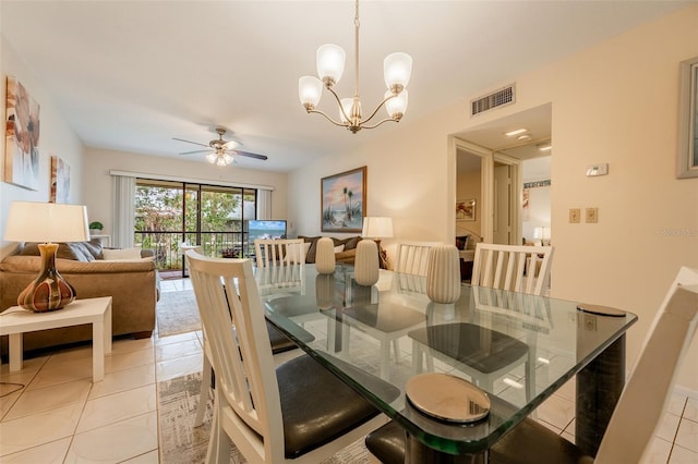 dining space with light tile patterned floors and ceiling fan with notable chandelier