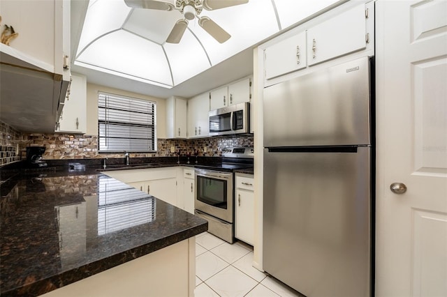 kitchen with decorative backsplash, white cabinetry, sink, and stainless steel appliances