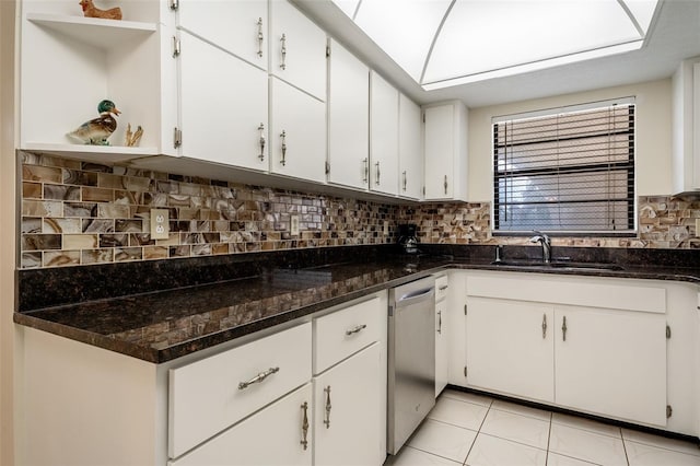 kitchen featuring dishwasher, white cabinetry, sink, and light tile patterned floors