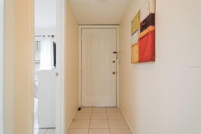 hall with light tile patterned floors