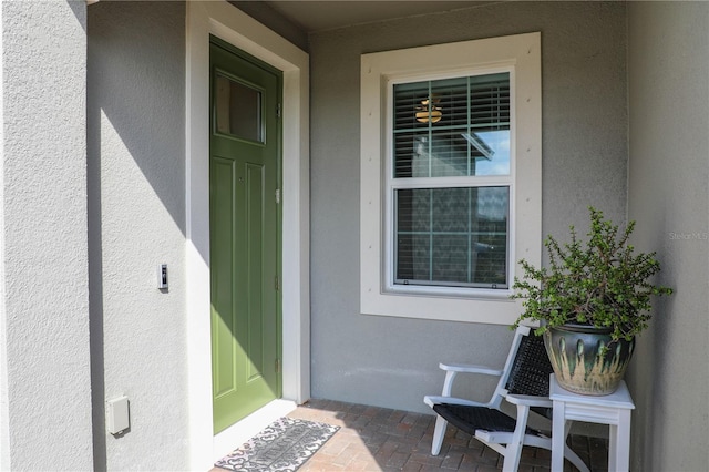 view of exterior entry with stucco siding