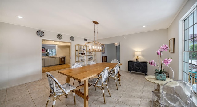 tiled dining room featuring a chandelier