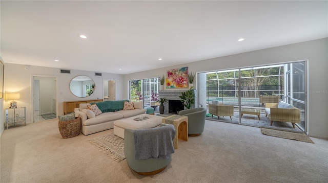 carpeted living room with a fireplace