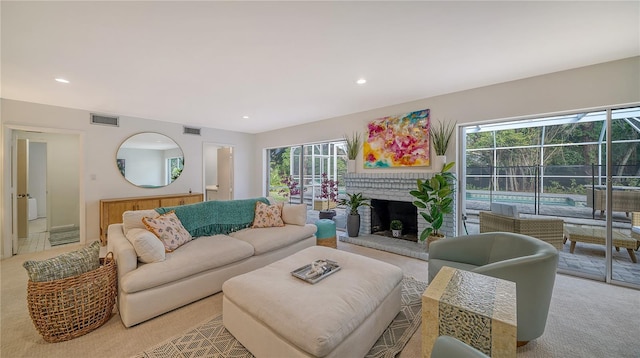 carpeted living room with a brick fireplace