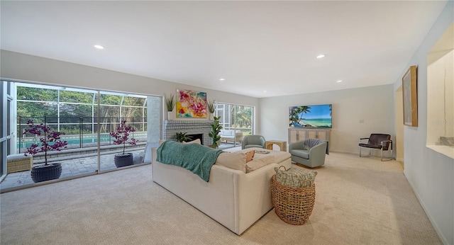 living room featuring a brick fireplace and light colored carpet