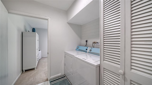 clothes washing area with washing machine and dryer and light colored carpet