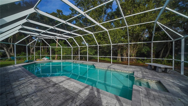 view of swimming pool featuring a lanai and a patio area