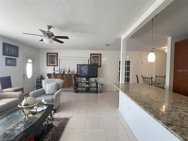 tiled living room featuring ceiling fan