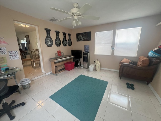 interior space featuring tile patterned flooring and ceiling fan