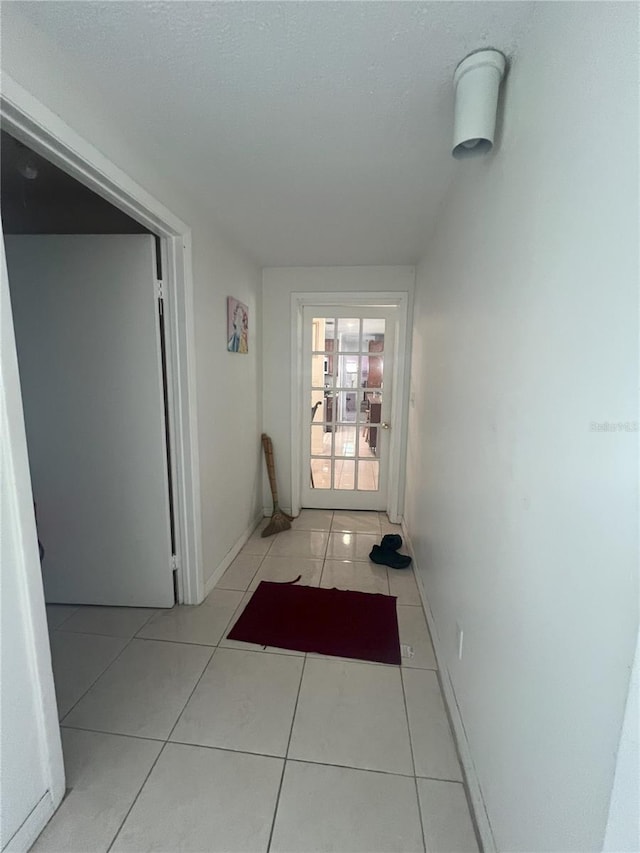 corridor with light tile patterned floors