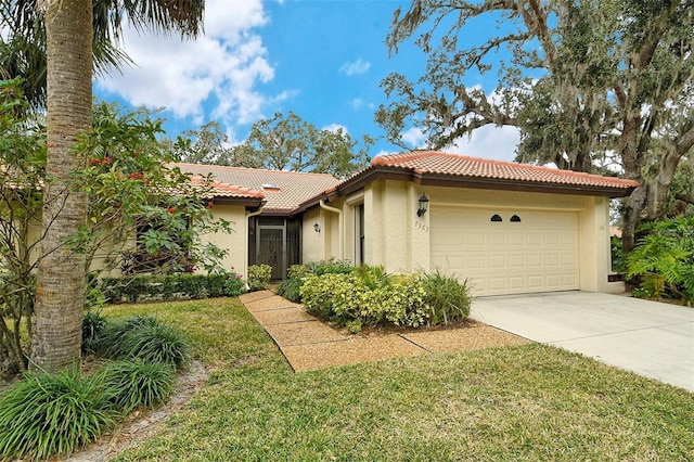 view of front of home with a tiled roof, a front lawn, concrete driveway, stucco siding, and a garage