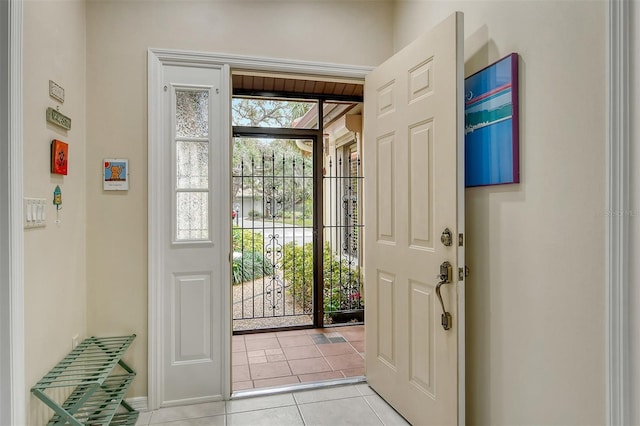 entryway featuring light tile patterned floors and a healthy amount of sunlight