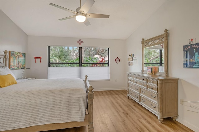 bedroom featuring ceiling fan, lofted ceiling, and light hardwood / wood-style flooring