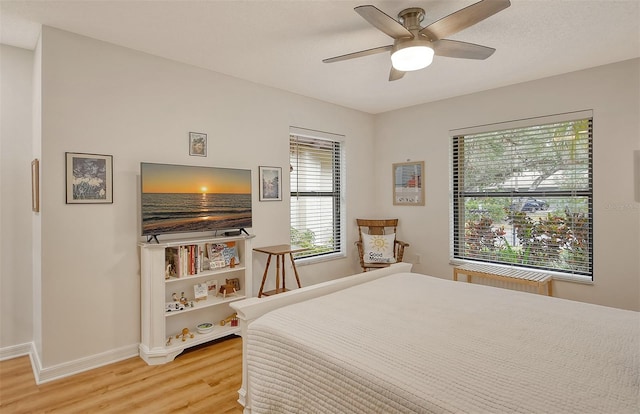 bedroom with ceiling fan and hardwood / wood-style flooring