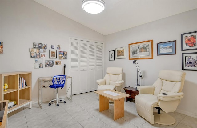 sitting room with lofted ceiling and light tile patterned flooring