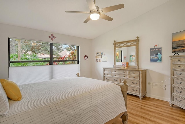bedroom featuring light wood-type flooring, vaulted ceiling, baseboards, and a ceiling fan