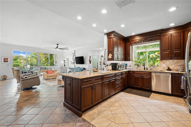 kitchen featuring ceiling fan, a healthy amount of sunlight, stainless steel dishwasher, kitchen peninsula, and light tile patterned flooring