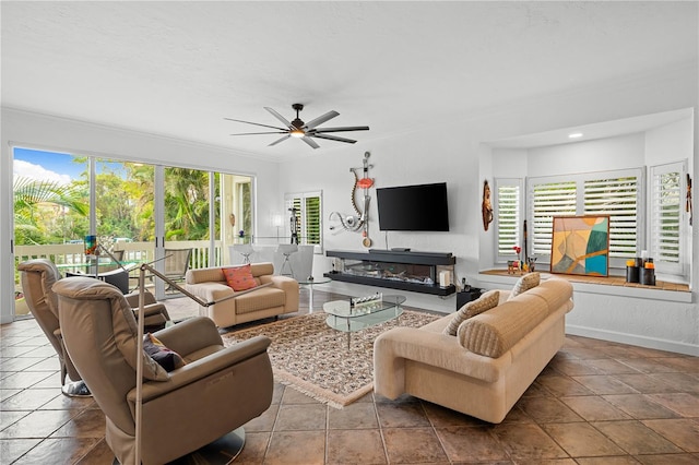 living room featuring ceiling fan and crown molding