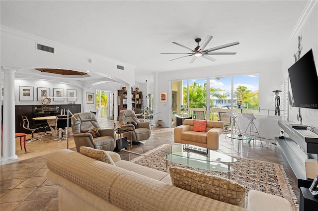 tiled living room featuring ceiling fan and crown molding