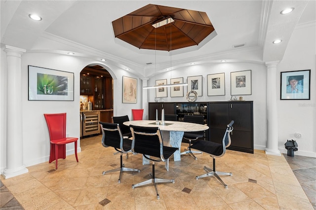 dining room featuring a tray ceiling, beverage cooler, and ornamental molding