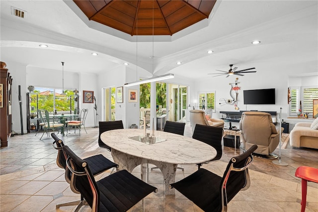 dining room featuring a tray ceiling, ceiling fan, and crown molding