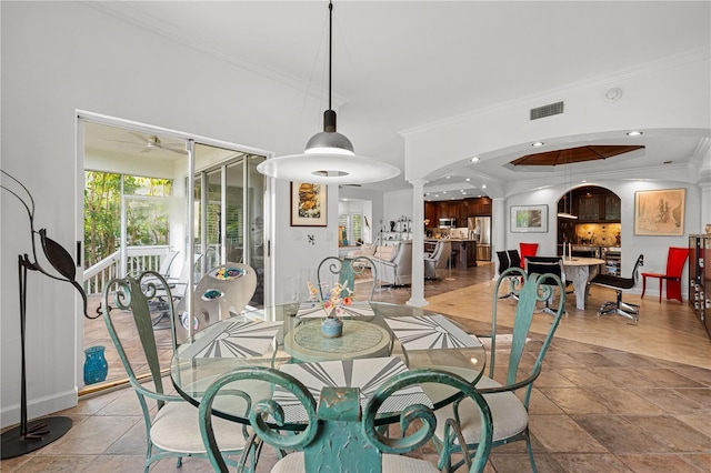 dining area with decorative columns, ceiling fan, and ornamental molding