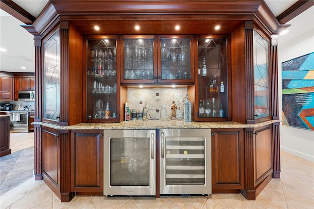 bar featuring decorative backsplash, stainless steel appliances, and beverage cooler