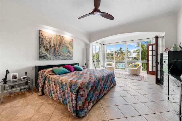 tiled bedroom with ceiling fan, ornamental molding, and french doors