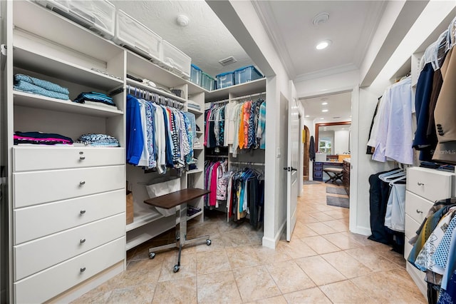 walk in closet featuring light tile patterned flooring