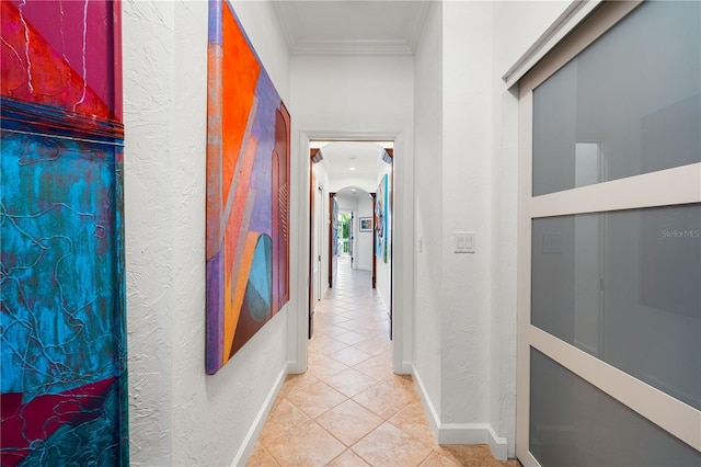 hallway with light tile patterned flooring and ornamental molding