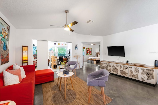 living room with lofted ceiling, a textured ceiling, and ceiling fan