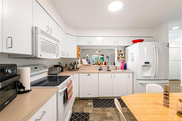 kitchen featuring white appliances, ceiling fan, white cabinetry, and sink