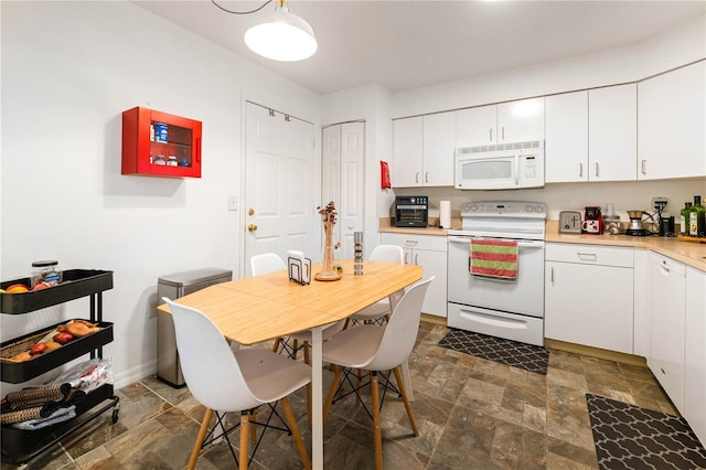 kitchen featuring white appliances and white cabinets