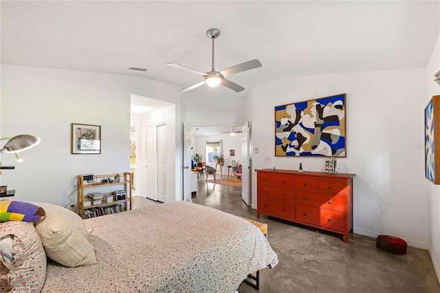 bedroom featuring lofted ceiling, ceiling fan, and a closet