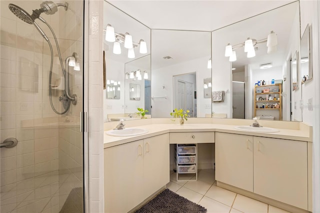 bathroom with walk in shower, tile patterned flooring, and vanity