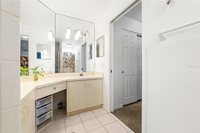 bathroom featuring tile patterned flooring and vanity