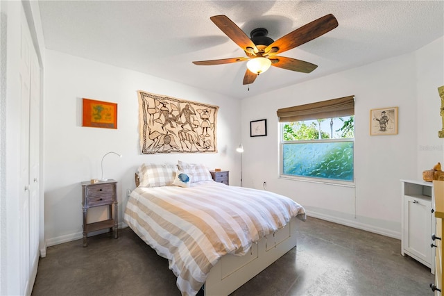 bedroom with a textured ceiling and ceiling fan